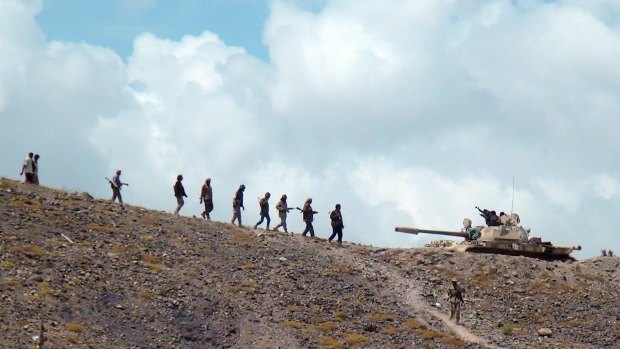 Militiamen loyal to the Yemeni presidency  on a hill overlooking the al-Anad air base in Lahej.