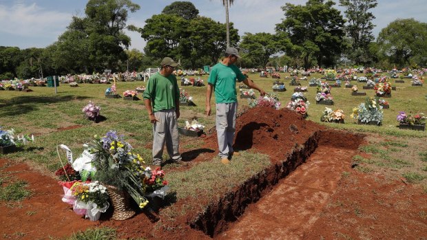 Cemetery workers prepare burial sites in Chapeco, Brazil.