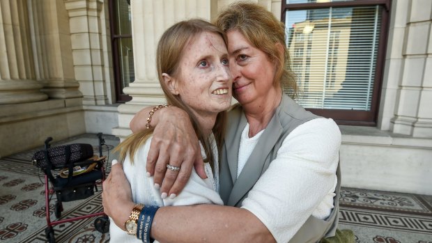 Nia Sims, who suffers from the terminal illness scleroderma, and her friend Jane Morris celebrate the decision in Victoria's lower house to pass the dying with dignity bill.