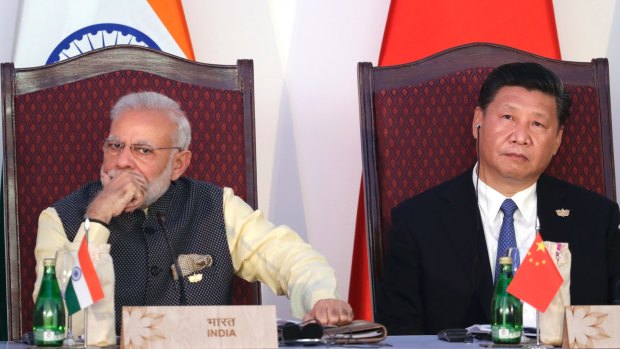 Indian Prime Minister Narendra Modi, left, and Chinese President Xi Jinping listen to a speech during the BRICS Leaders Meeting in Goa, India, last year.