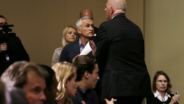 A security guard for Republican presidential candidate Donald Trump removes Miami-based Univision anchor Jorge Ramos from a news conference.
