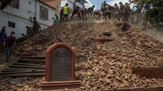 Volunteers and emergency workers search for bodies buried under the debris of one of the temples at Basantapur Durbar Square in Kathmandu, Nepal.