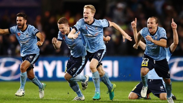 Ecstatic: Sydney FC players celebrate winning the grand final.