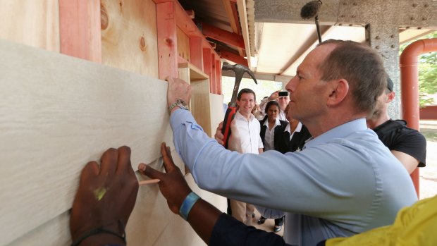 Mr Abbott at work on the cubby house.