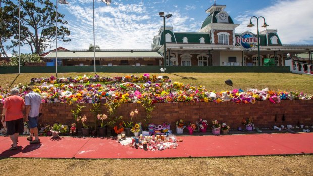 Floral tributes outside Dreamworld where the deaths of four people have raised questions about workplace laws in Queensland and prompted a safety review of the state's theme parks.  