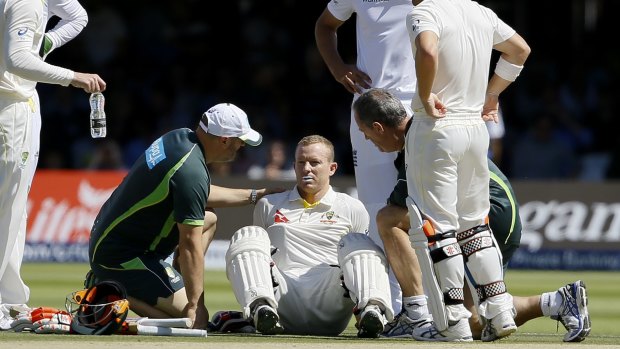 Concern: Australian batsman Chris Rogers sits on the ground before retiring on the fourth day of the Ashes Test at Lord's.