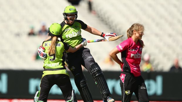 Happy days: Thunder batters Claire Koski and Lauren Cheatle  celebrate after winning the Women's Big Bash League final at the MCG.