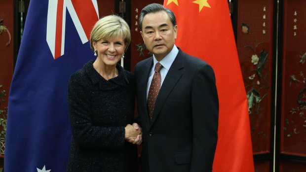 Australian Foreign Minister Julie Bishop shakes hands with Chinese Foreign Minister Wang Yi.