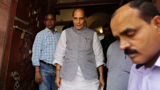 Indian Home Minister Rajnath Singh, centre, comes out from parliament house after making a statement on the attacks on four men beaten while trying to skin a dead cow.