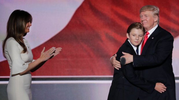 Donald Trump hugs his son Barron as wife Melania watches during the final day of the Republican National Convention in July.
