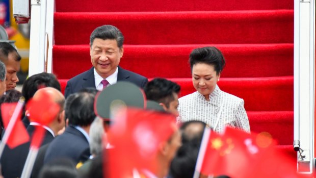 Chinese President Xi Jinping and first lady Peng Liyuan arrive at Hong Kong International Airport on Thursday.