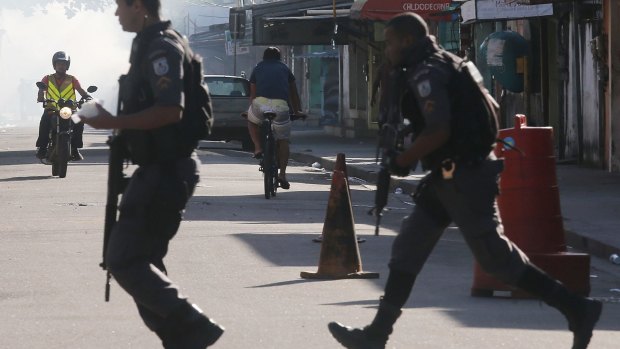 Military Police officers patrol in the Cidade de Deus 'City of God' favela community.