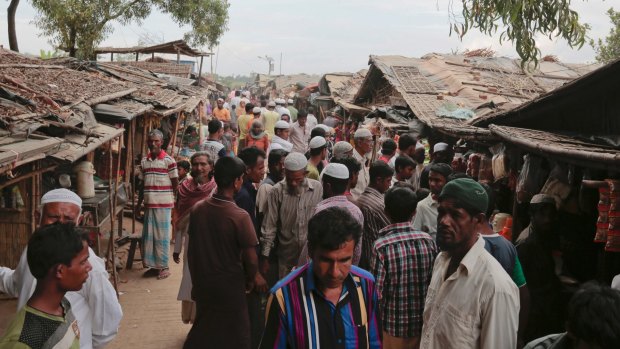 Rohingya Muslims from Myanmar mingle in an alley at an unregistered refugee camp in Teknaf, near Cox's Bazar, Bangladesh.