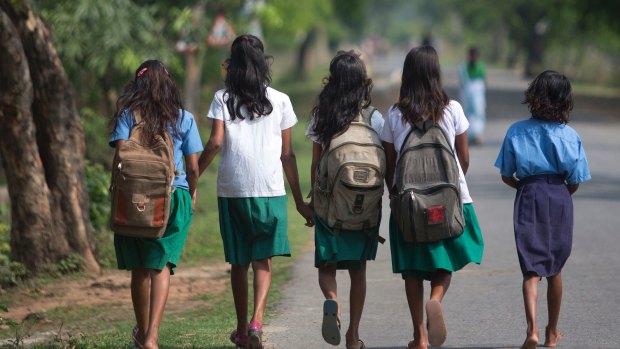 Indian girls walk to a school.