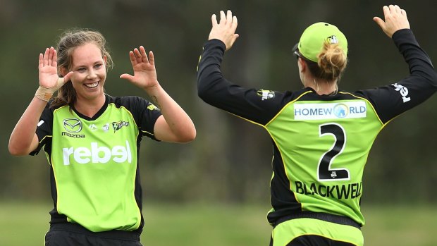 Breakthrough: Sam Bates celebrates with Alex Blackwell after taking the wicket of the Heat's Delissa Kimmince at Blacktown International Sportspark.