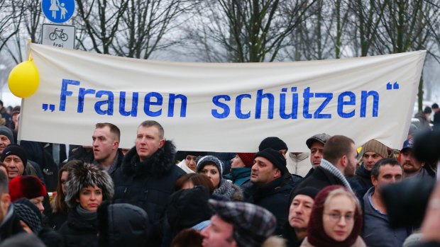 Grassroots or astroturfing?: The 'International Convention of German Russians' protest  in Berlin under a sign that reads "protect women".  