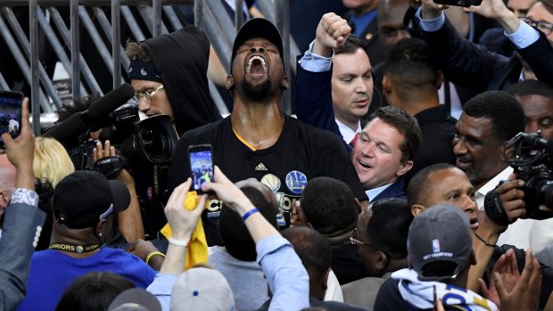 Beer o'clock: Kevin Durant celebrates after the Warriors' victory.