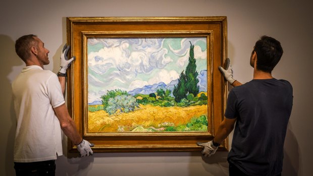 NGV staff hang van Gogh piece, A wheatfield with cypresses, ahead of the <i>Van Gogh and the Seasons</i> exhibition.