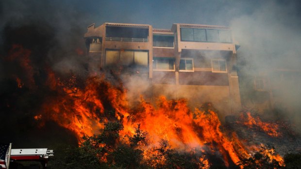 A wildfire threatens a home in Ventura, California.