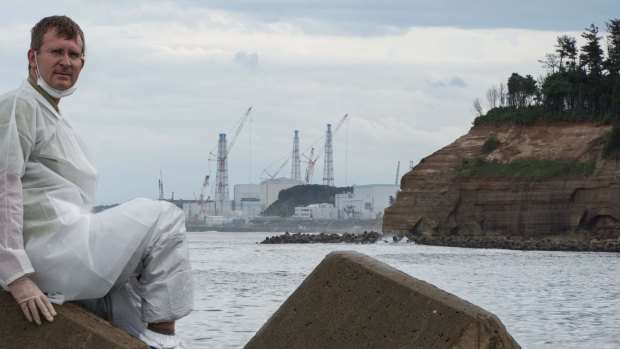 Photographer Arkadiusz Podniesinski in his protective radiation clothing at Fukushima harbour.