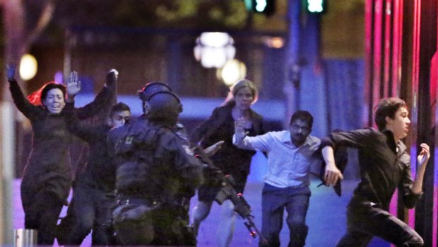 Hostages run from the Lindt Cafe towards Special Operations Police in Martin Place. 