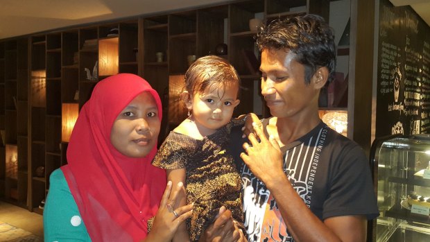 Ali Jasmin, who was jailed by Australia as a child, with his wife Baualan and his 18-month-old daughter Aisah Nuruna.