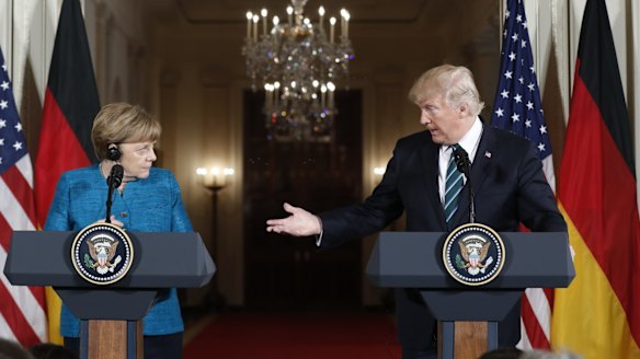 Donald Trump and Angela Merkel have met for the first time in an awkward encounter that could not disguise the gulf that separates them.