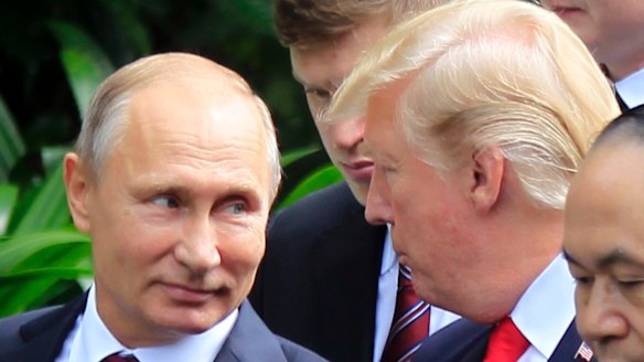 Vladimir Putin and Donald Trump talk as they arrive for the family photo session during the Asia-Pacific Economic Co-operation Summit in Danang on Saturday