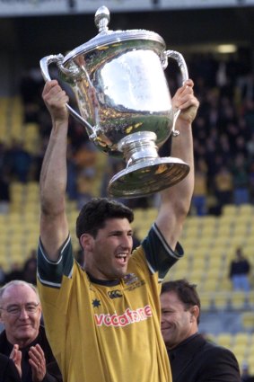What a day: John Eales holds aloft the Bledisloe Cup after a memorable match at Wellington in 2000.