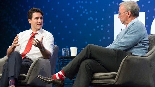 Canada's Prime Minister Justin Trudeau, left, speaks with Alphabet Executive Chairman Eric Schmidt at the Google Go North conference at the Evergreen Brickworks in Toronto.