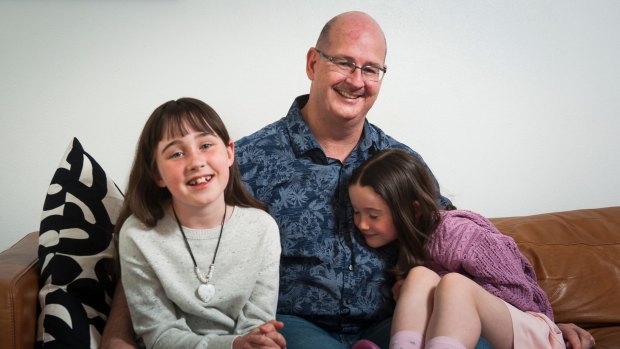 Scott Chamberlain at home in Campbell with his daughters Emma, 8, and Sophie, 6.