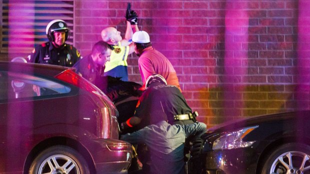 Dallas Police shield bystanders after shots were fired.