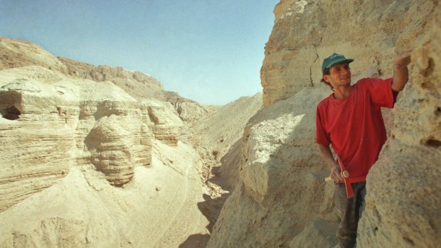 Roi Porat, an Israeli student of archaeology, works near the remains of a cave found at the West Bank archeological site of Qumran, near the Dead Sea in 2001. 