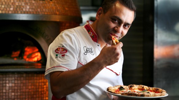 Johnny Di Francesco tucks into a margherita pizza.