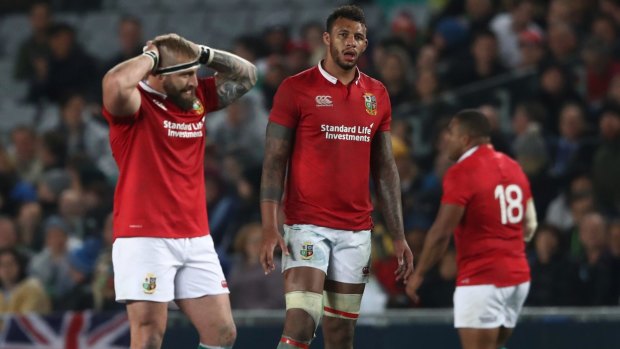 Well beaten: Lions players after their loss to the Blues.