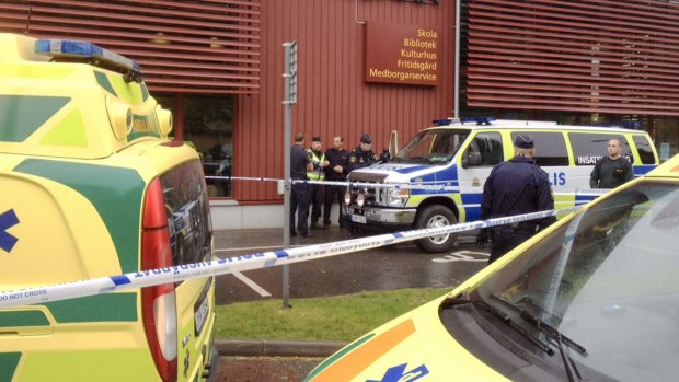 Emergency services attend the scene after a masked man attacked people with a sword, at the Kronan school in Trollhattan, near Goteborg, Sweden.
