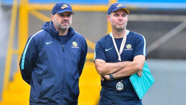 Tight-lipped: Socceroos head coach Ange Postecoglou with assistant Ante Milicic have given no clue as to their preferred line-up against Honduras.