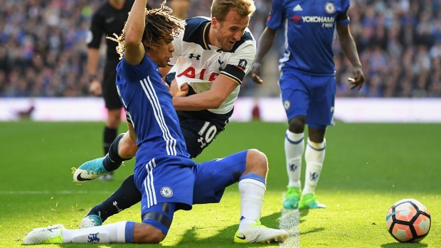 Chasing dreams: Tottenham's Harry Kane looks to best Chelsea's Nathan Ake, before being tackled.