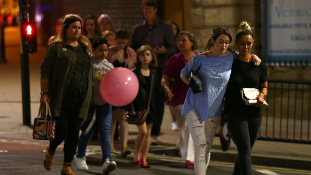 Members of the public are escorted from the Manchester Arena after the suicide bombing attack.