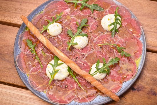 Beef carpaccio, sliced as thin as tissue paper.