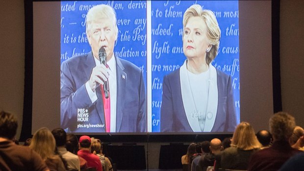 Republican presidential nominee Donald Trump, left, and Democratic presidential nominee Hillary Clinton are displayed on a big screen at the University of Cincinnati.