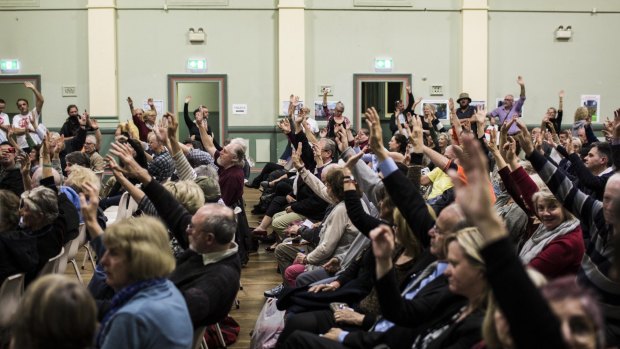 Attendants at a Stop WestConnex meeting at the Balmain Town Hall demonstrate the local opposition to the project. 