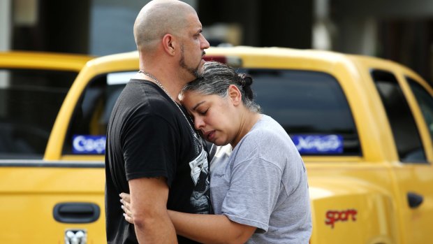 Ray Rivera, a DJ at Pulse nightclub, is consoled by a friend after the shooting.