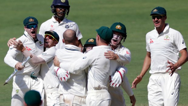 Boilover: The Australians celebrate winning the first Test against India in Pune.