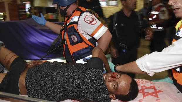 The wounded Eritrean man is evacuated from the scene of an attack in Beersheba, Israel. He later died of his wounds.