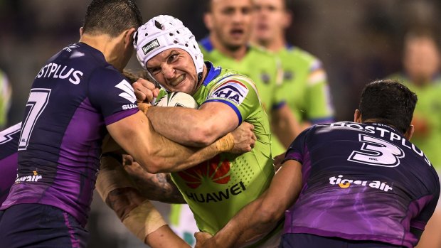 Raiders skipper  Jarrod Croker charges into the Storm defence.