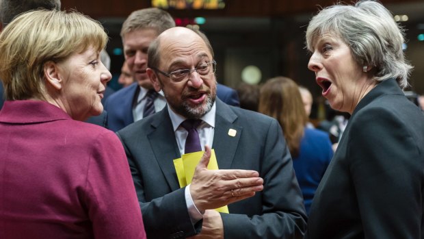 German Chancellor Angela Merkel, left, speaks with British Prime Minister Theresa May, right, and then-European Parliament President Martin Schulz in 2016.