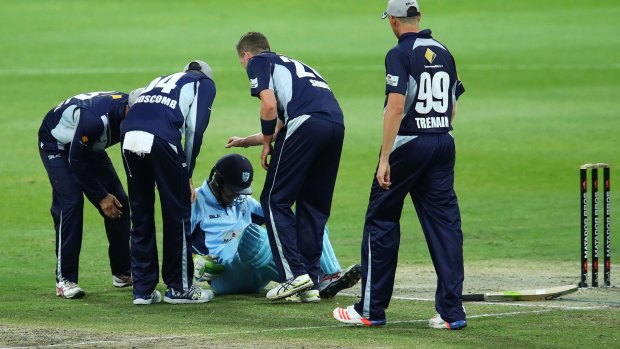 Victoria's Peter Siddle checks to see if Daniel Hughes is OK after he was struck on the helmet by a short delivery in a Matador Cup game last Friday.