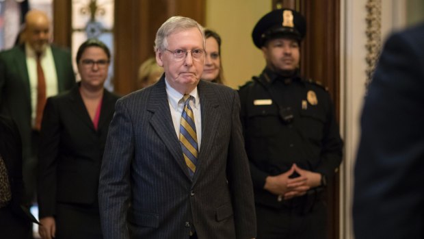 After speaking on the floor, Senate Majority Leader Mitch McConnell, leaves the chamber as a bitterly-divided Congress hurtled toward a government shutdown on Friday.