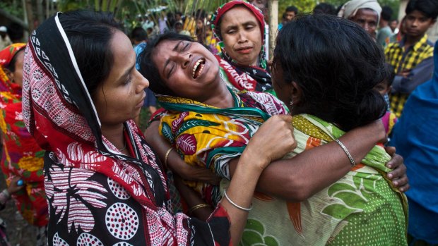 Relatives of Abu Hanif wail during his funeral in Naramari village in the northeastern Indian state of Assam. Two Muslim men, including Hanif, were beaten to death by a mob over allegations of cow theft in late April. 